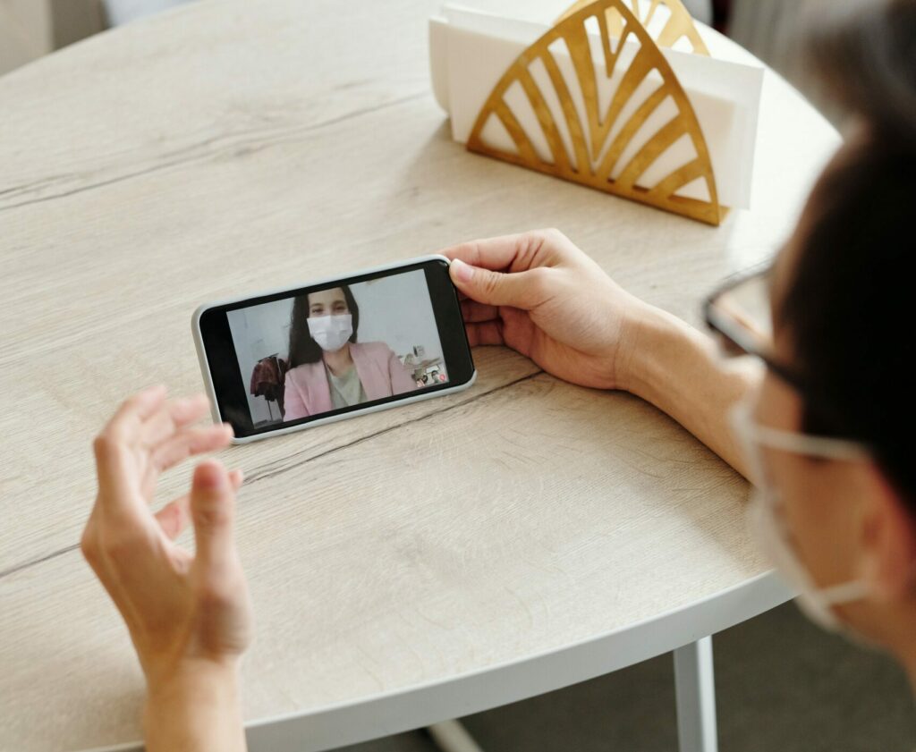 Practitioner and patient communicating via video call on a secure network solution provided by Deltapath