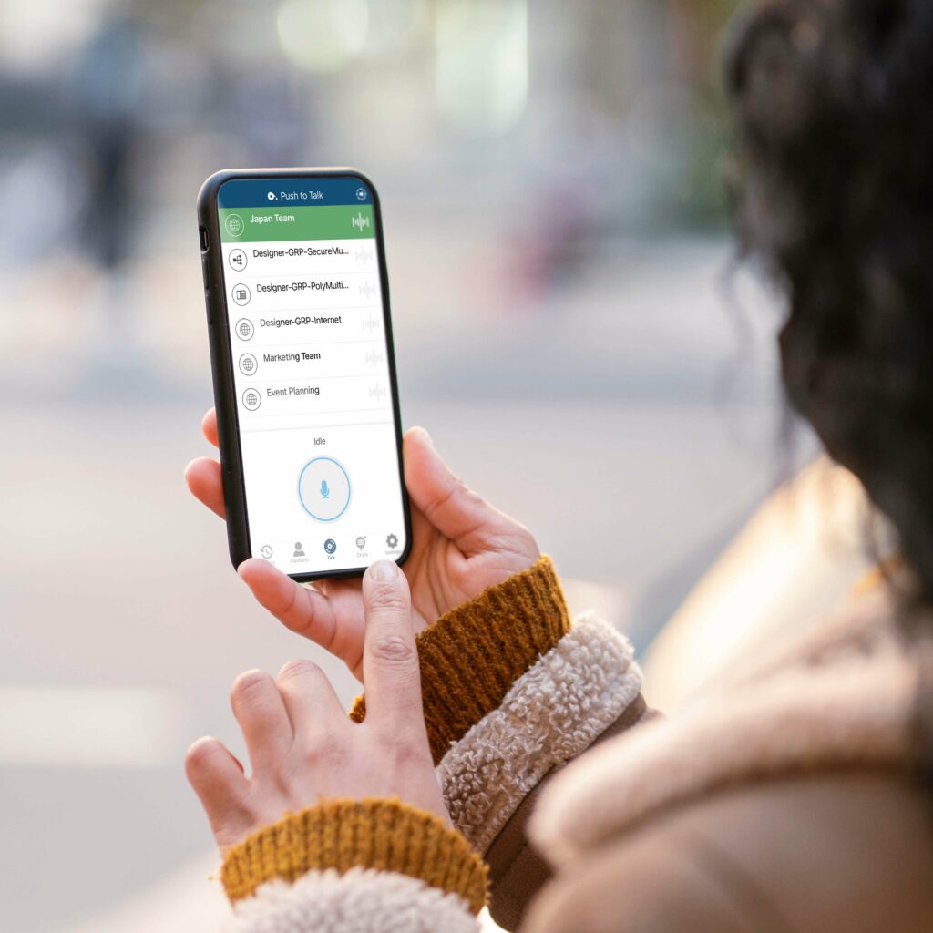 A women is using push-to-talk on her smartphone.
