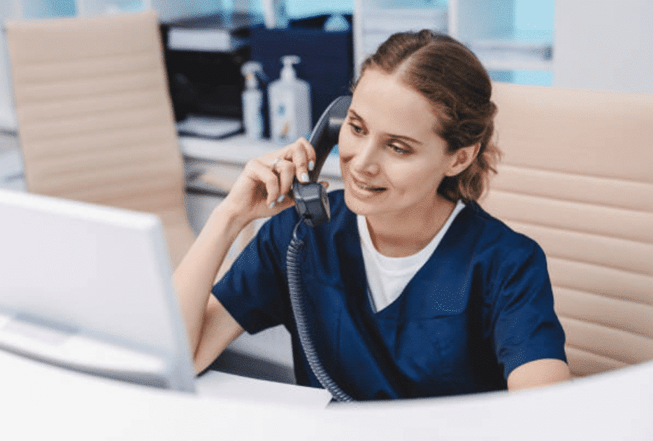 Image of a woman on a business phone system. | Deltapath