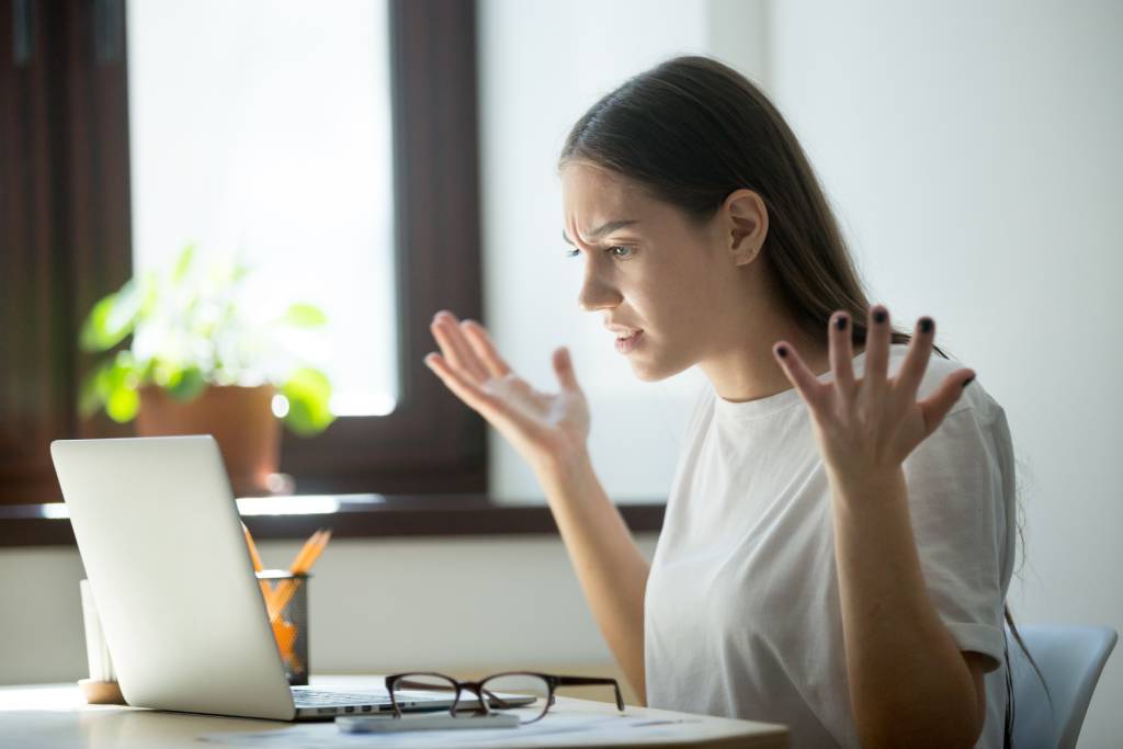Adult woman upset in front of laptop