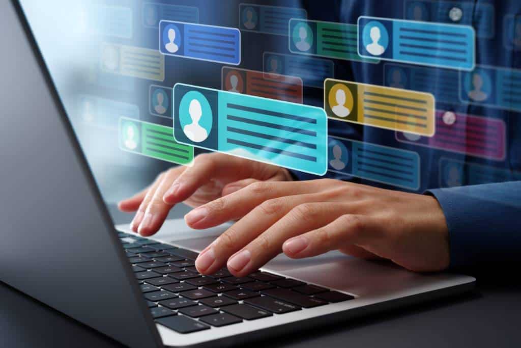 Hands typing on laptop